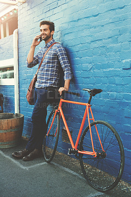 Buy stock photo Bicycle, transport and businessman with phone call in city for eco friendly, travel or b2b networking on wall background. Carbon footprint, communication or freelance agent cycling on Morocco commute