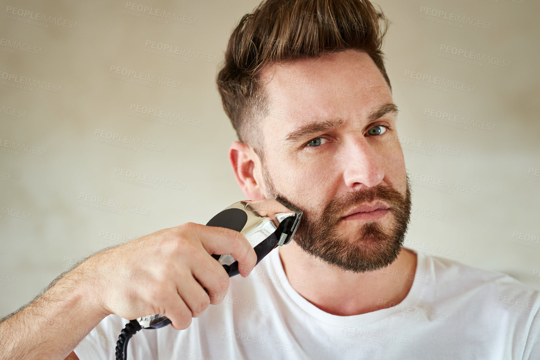 Buy stock photo Man, portrait and electric trimmer in bathroom for grooming, skincare or morning routine. Face, beard or serious person with shaver for cleaning, health or hair removal for hygiene in home for beauty