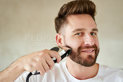 Buy stock photo Cropped shot of a handsome young man going through his morning routine in the bathroom