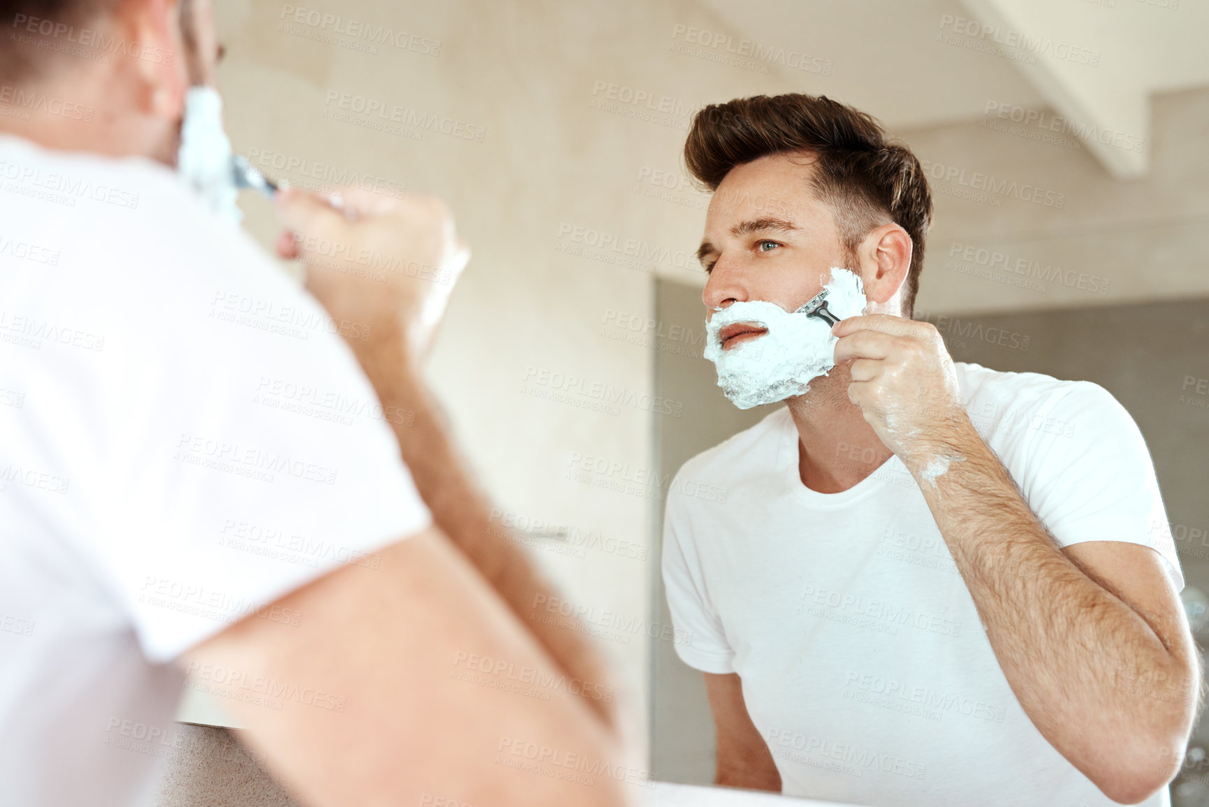 Buy stock photo Man, mirror and shaving face with razor in bathroom for grooming, skincare or morning routine. Reflection, foam and person cutting beard for cleaning, health and hair removal for hygiene in home