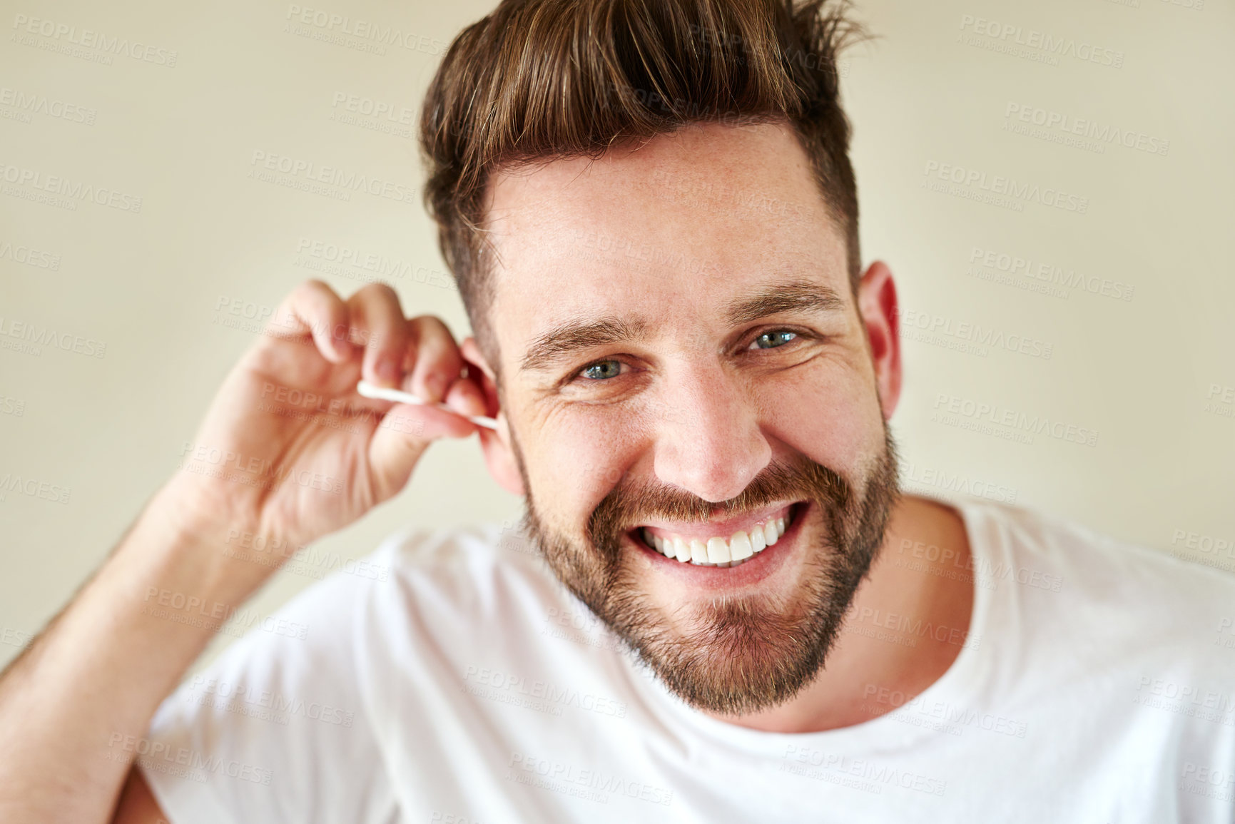 Buy stock photo Cropped shot of a handsome young man going through his morning routine in the bathroom