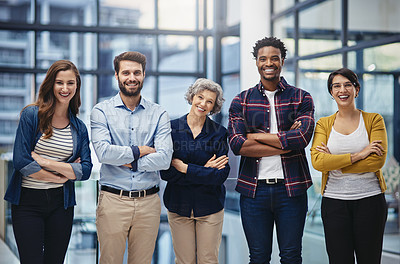 Buy stock photo Portrait of a group of creatives standing with their arms folded in an office