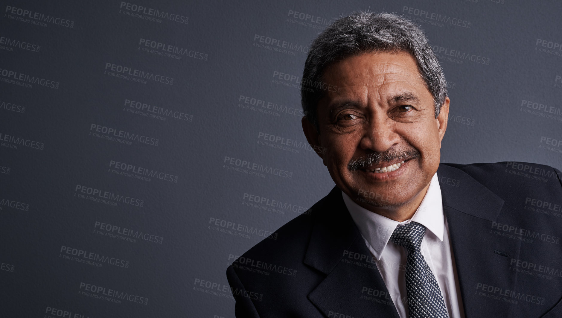 Buy stock photo Studio shot of a mature businessman posing against a dark background 