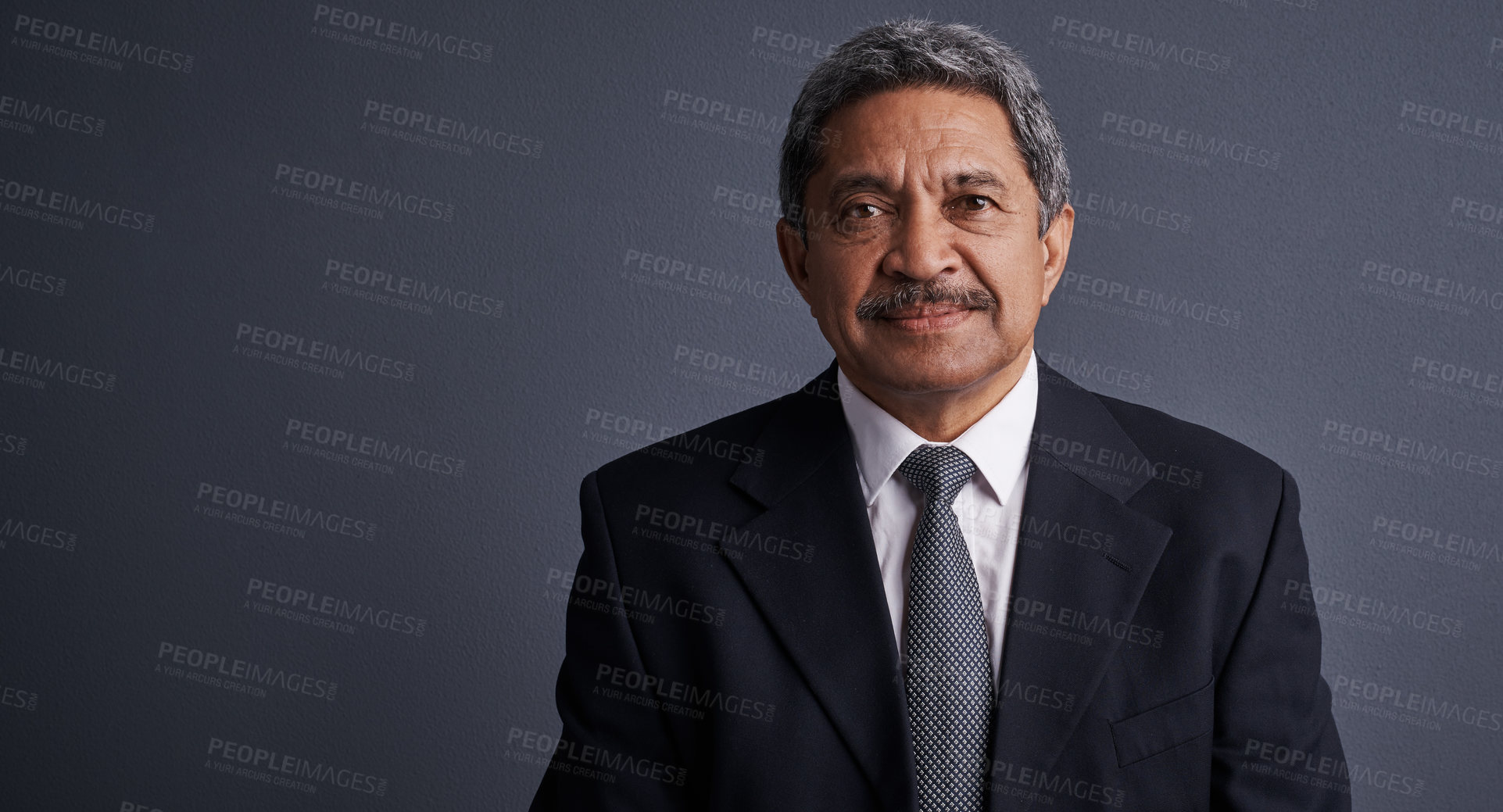 Buy stock photo Studio shot of a mature businessman posing against a dark background 