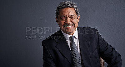 Buy stock photo Studio shot of a mature businessman posing against a dark background 