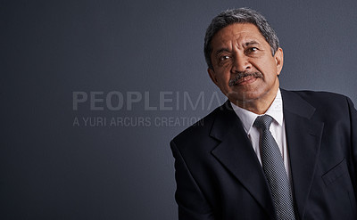 Buy stock photo Studio shot of a mature businessman posing against a dark background 