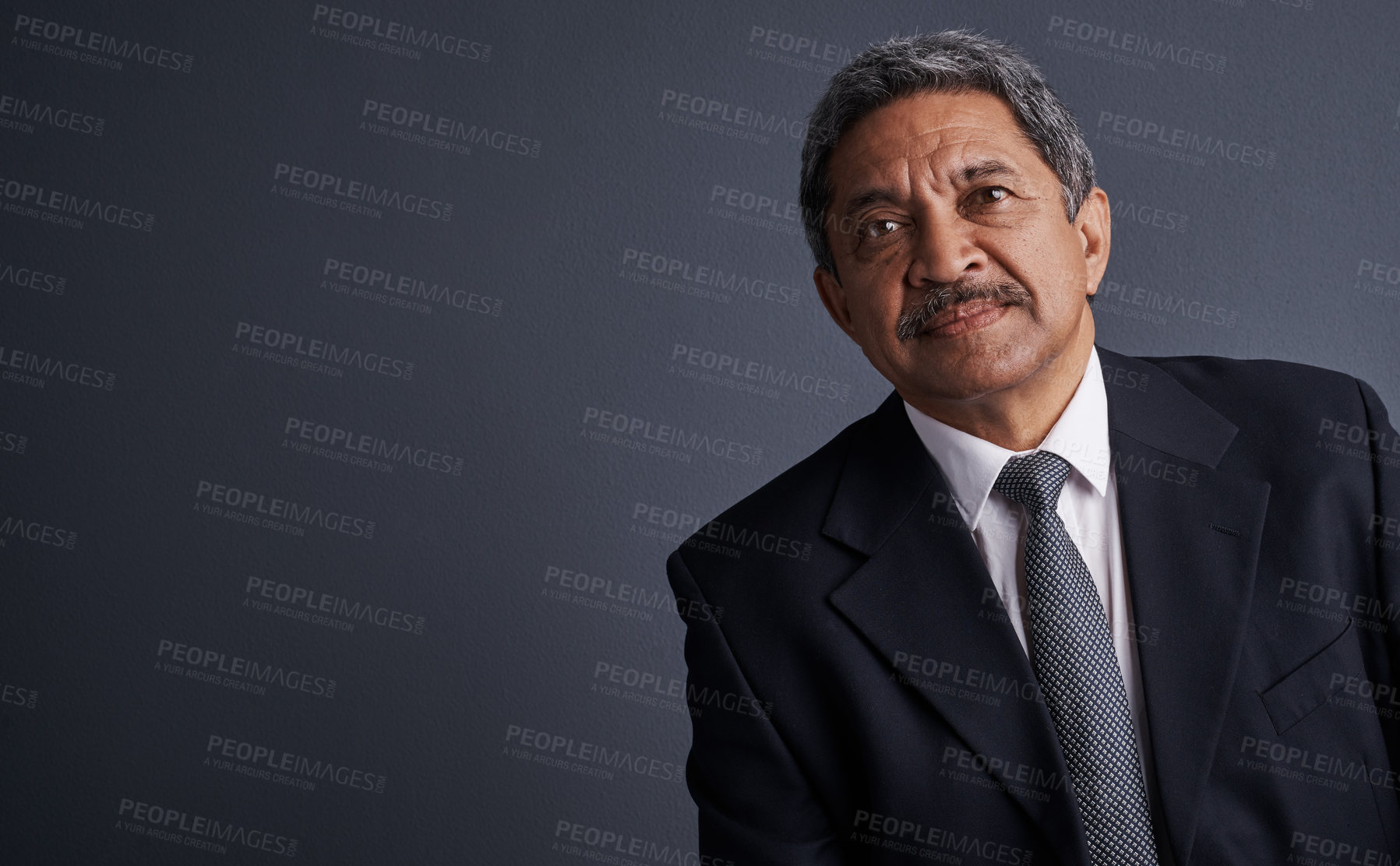 Buy stock photo Studio shot of a mature businessman posing against a dark background 