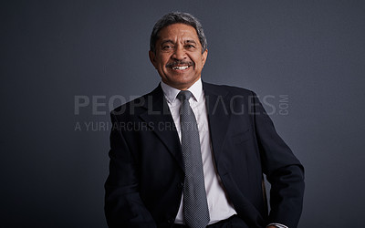 Buy stock photo Studio shot of a mature businessman posing against a dark background 