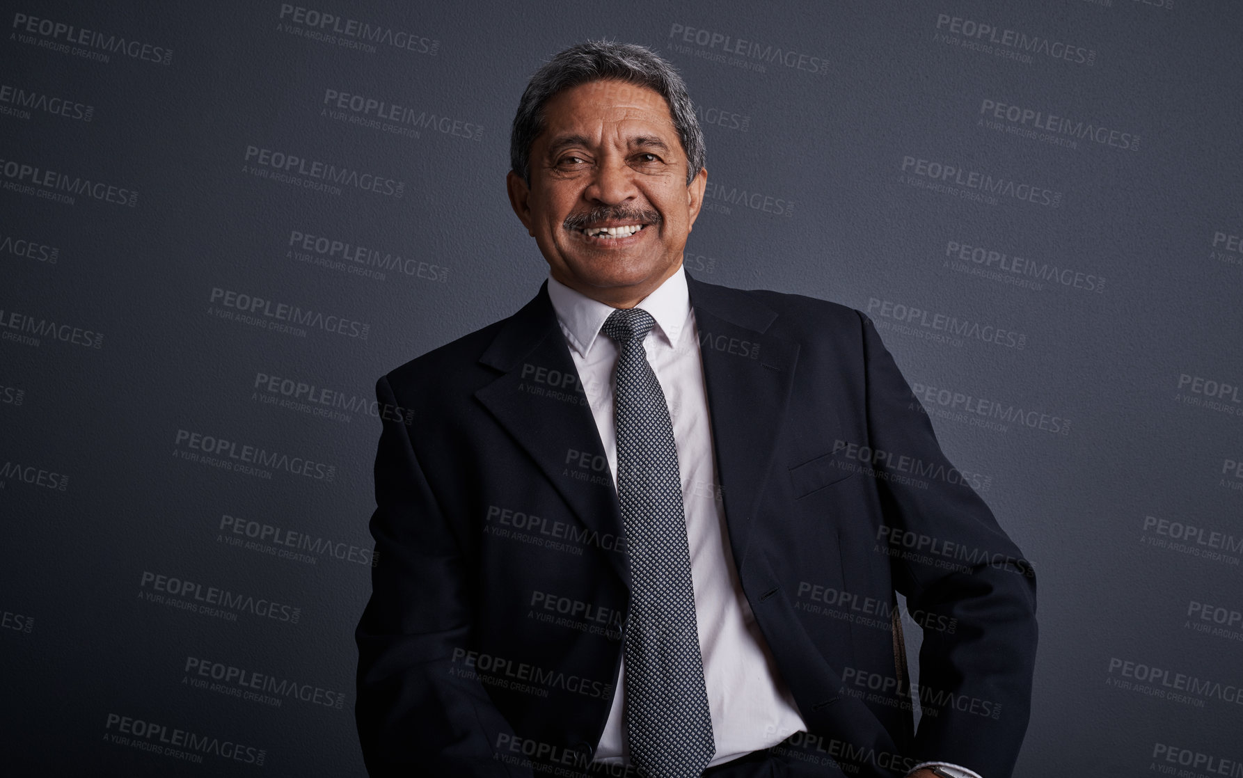 Buy stock photo Studio shot of a mature businessman posing against a dark background 