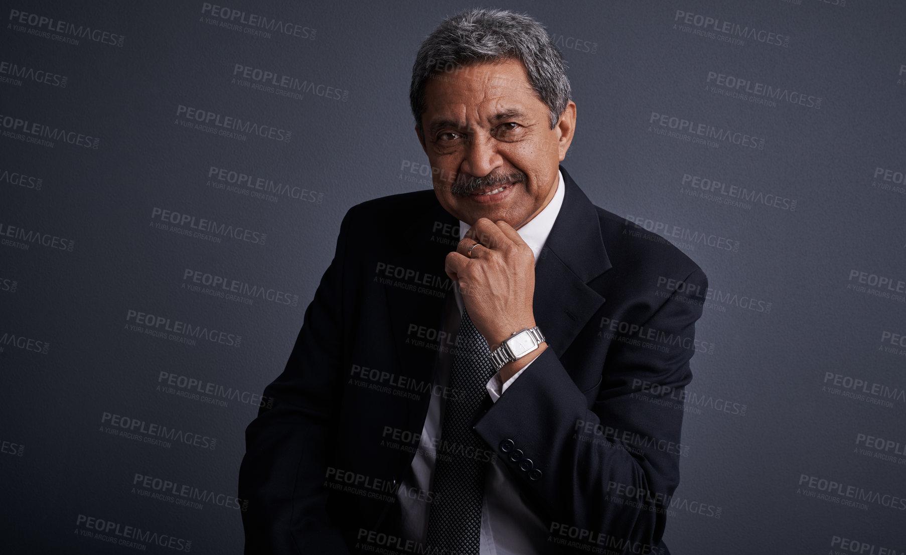 Buy stock photo Studio shot of a mature businessman posing against a dark background 