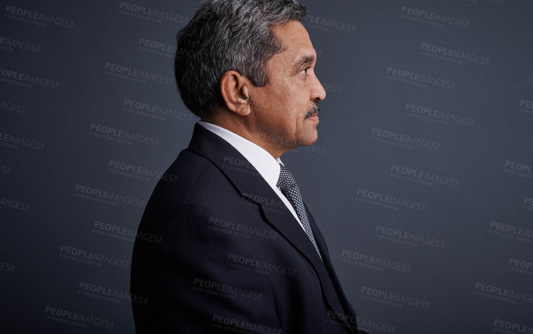 Buy stock photo Studio shot of a mature businessman posing against a dark background 