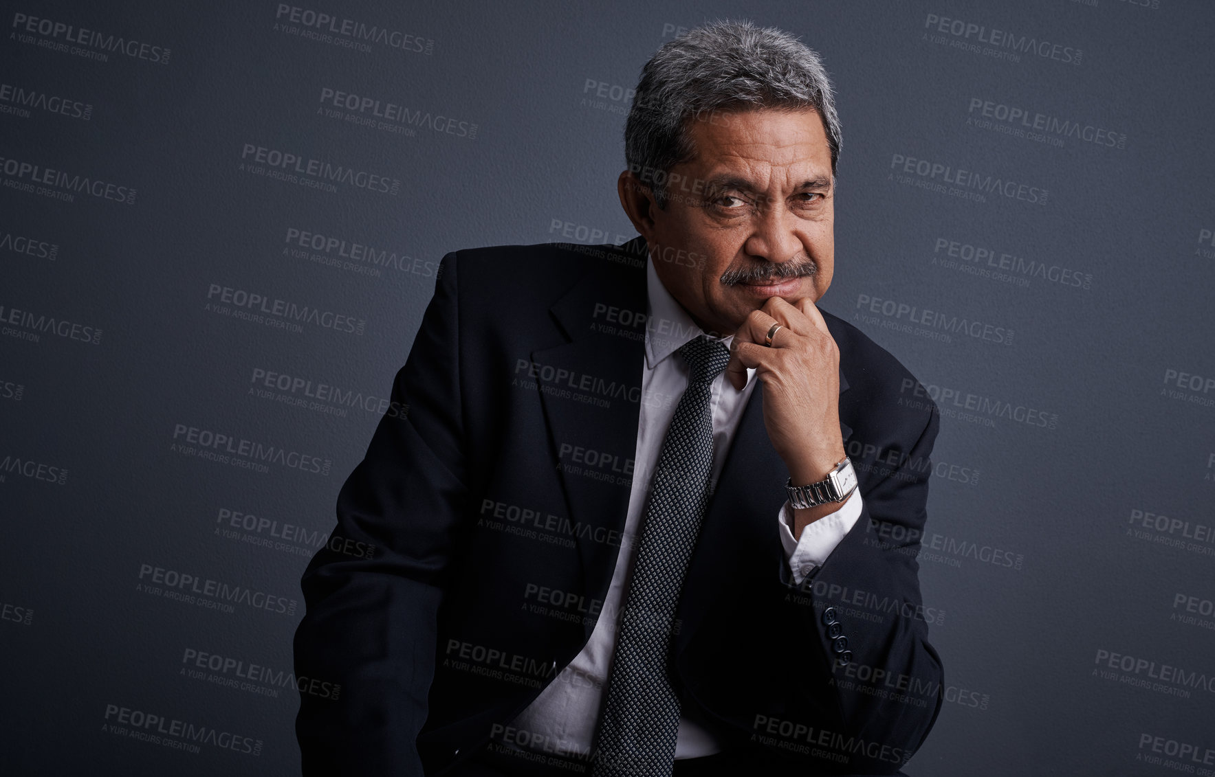 Buy stock photo Studio shot of a mature businessman posing against a dark background 