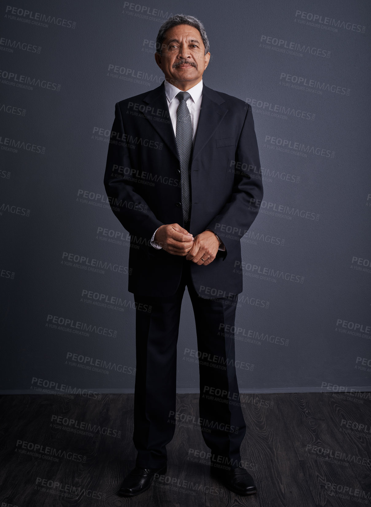 Buy stock photo Studio shot of a mature businessman posing against a dark background 