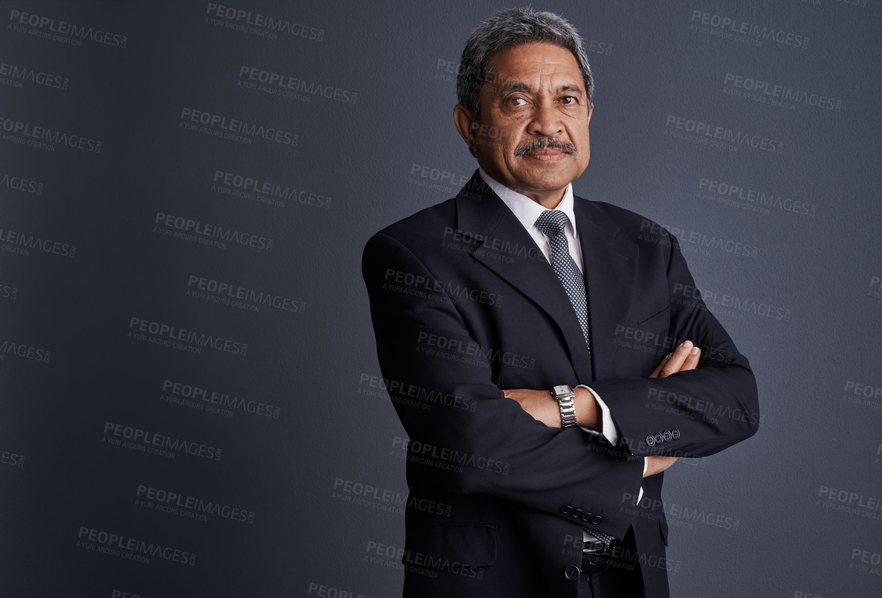 Buy stock photo Studio shot of a mature businessman posing against a dark background 