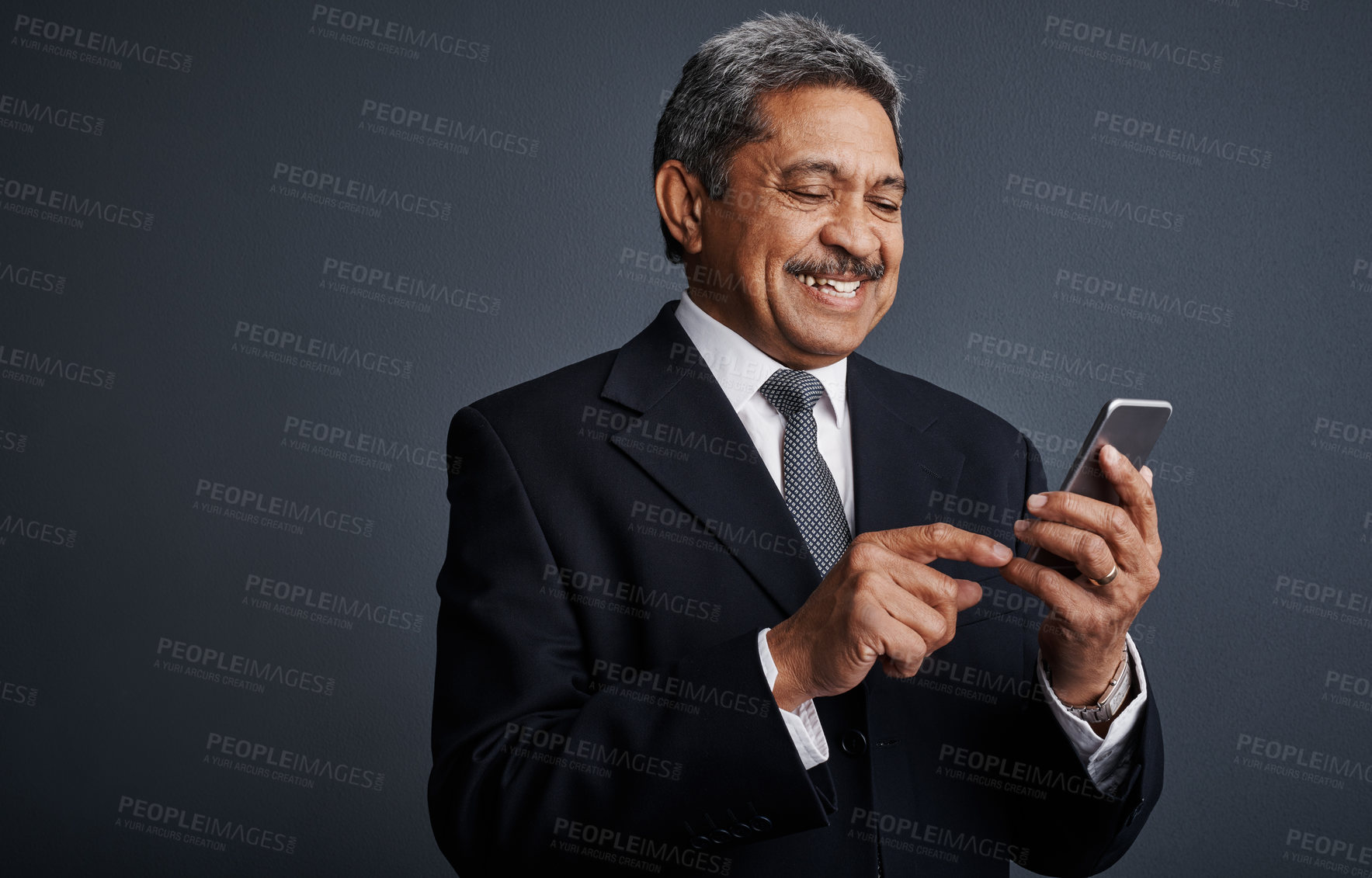 Buy stock photo Studio shot of a mature businessman using his cellphone