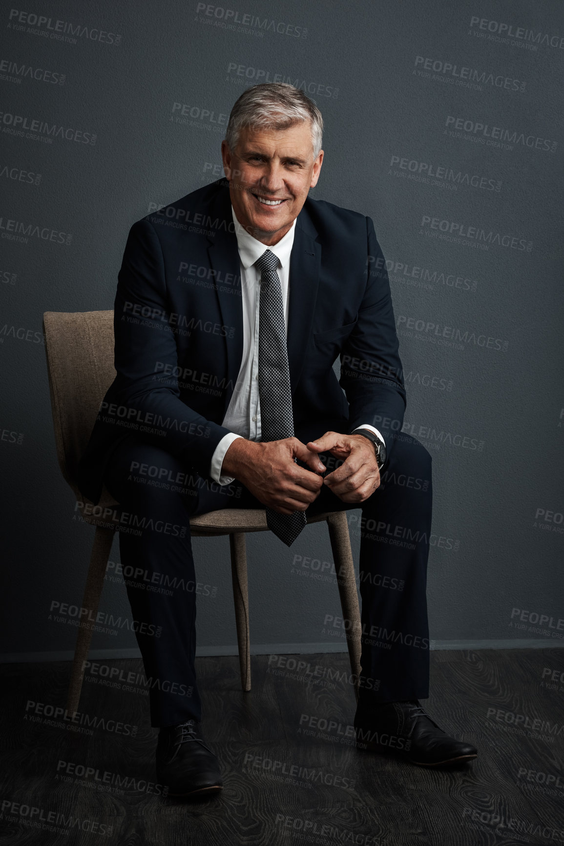 Buy stock photo Studio shot of a mature businessman posing against a grey background