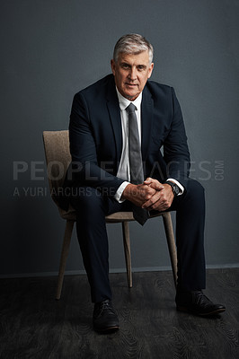 Buy stock photo Studio shot of a mature businessman posing against a grey background