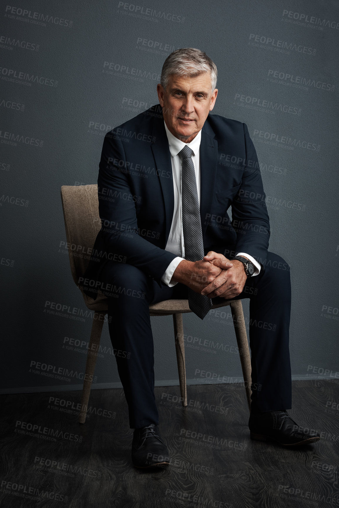 Buy stock photo Studio shot of a mature businessman posing against a grey background