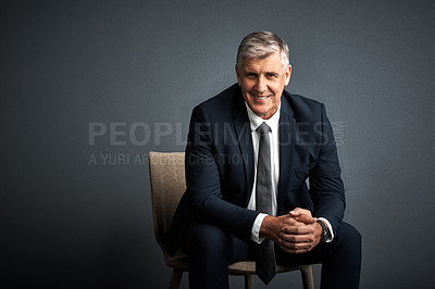 Buy stock photo Studio shot of a mature businessman posing against a grey background