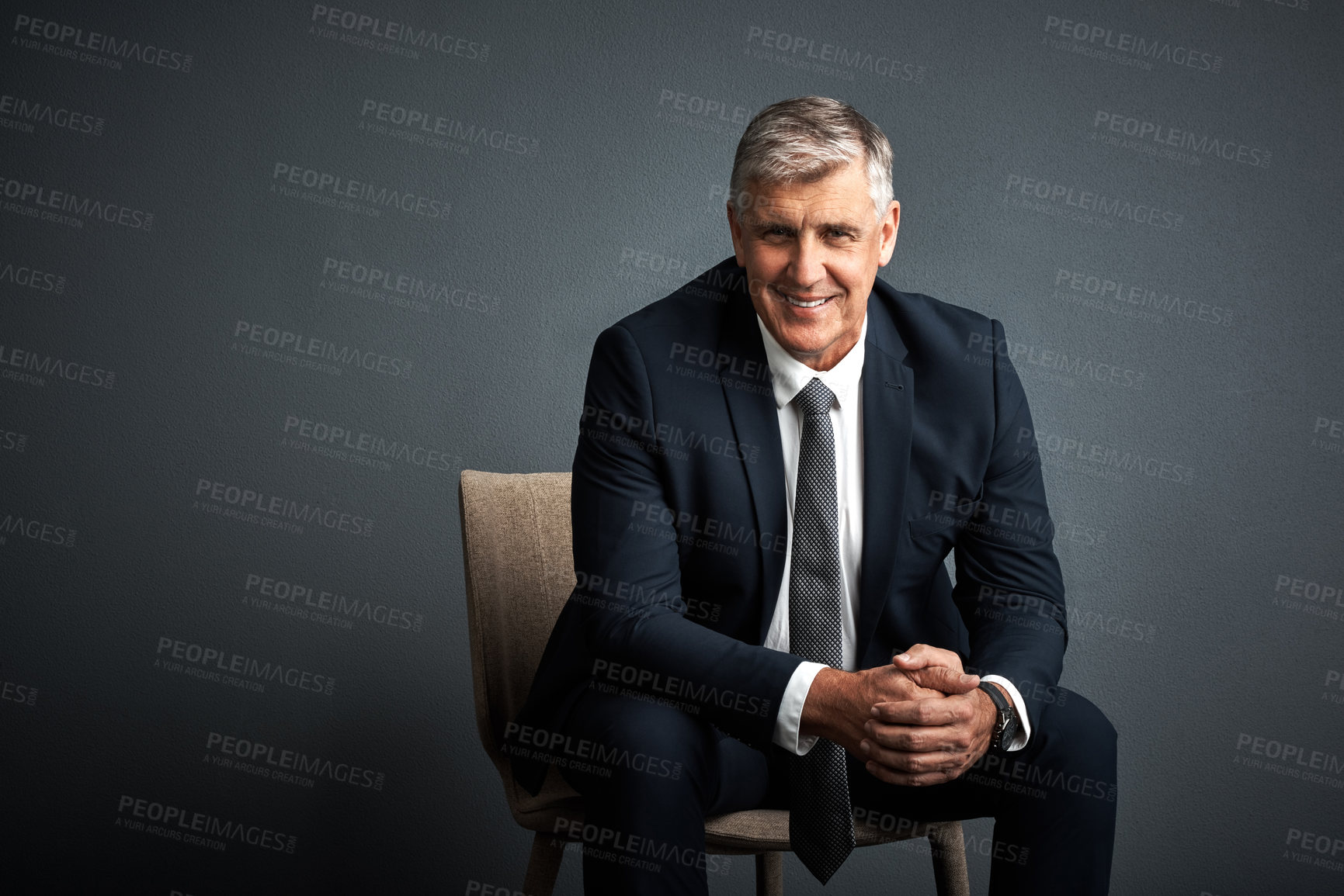 Buy stock photo Studio shot of a mature businessman posing against a grey background