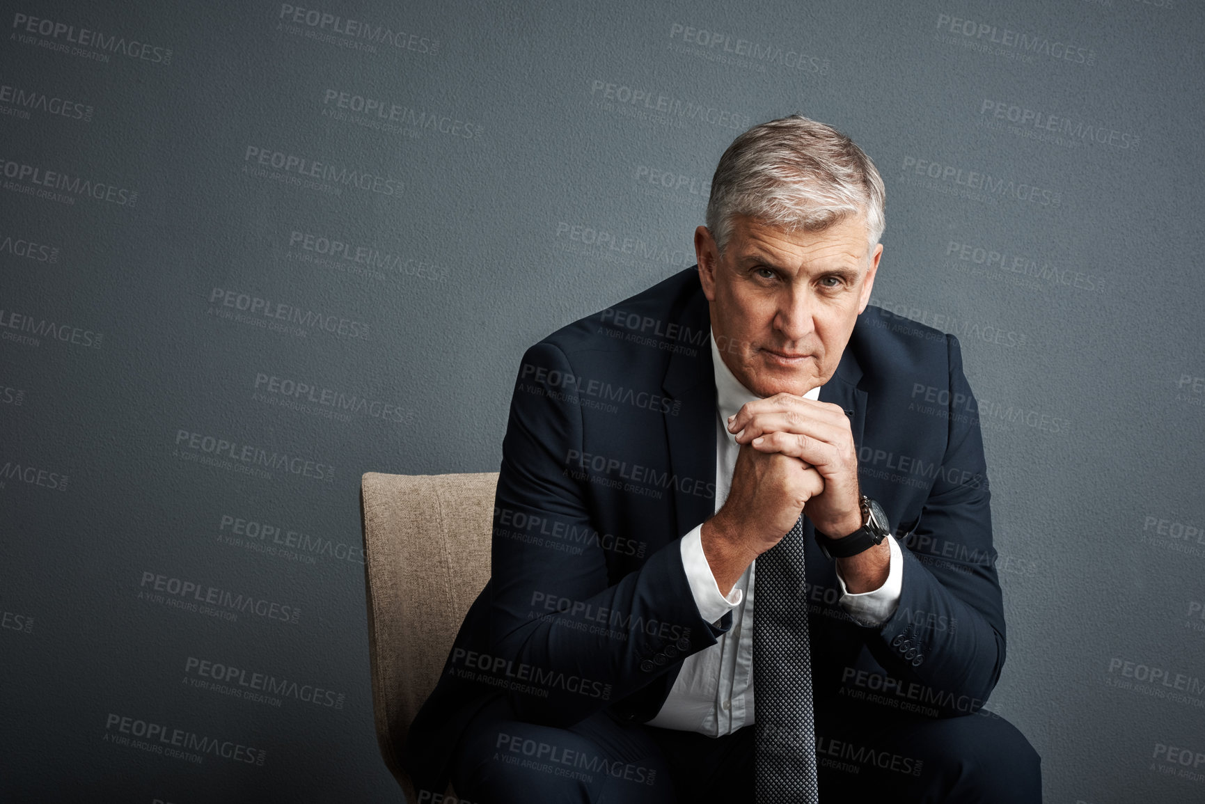 Buy stock photo Studio shot of a mature businessman posing against a grey background