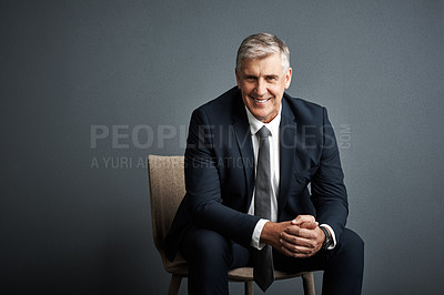 Buy stock photo Studio shot of a mature businessman posing against a grey background