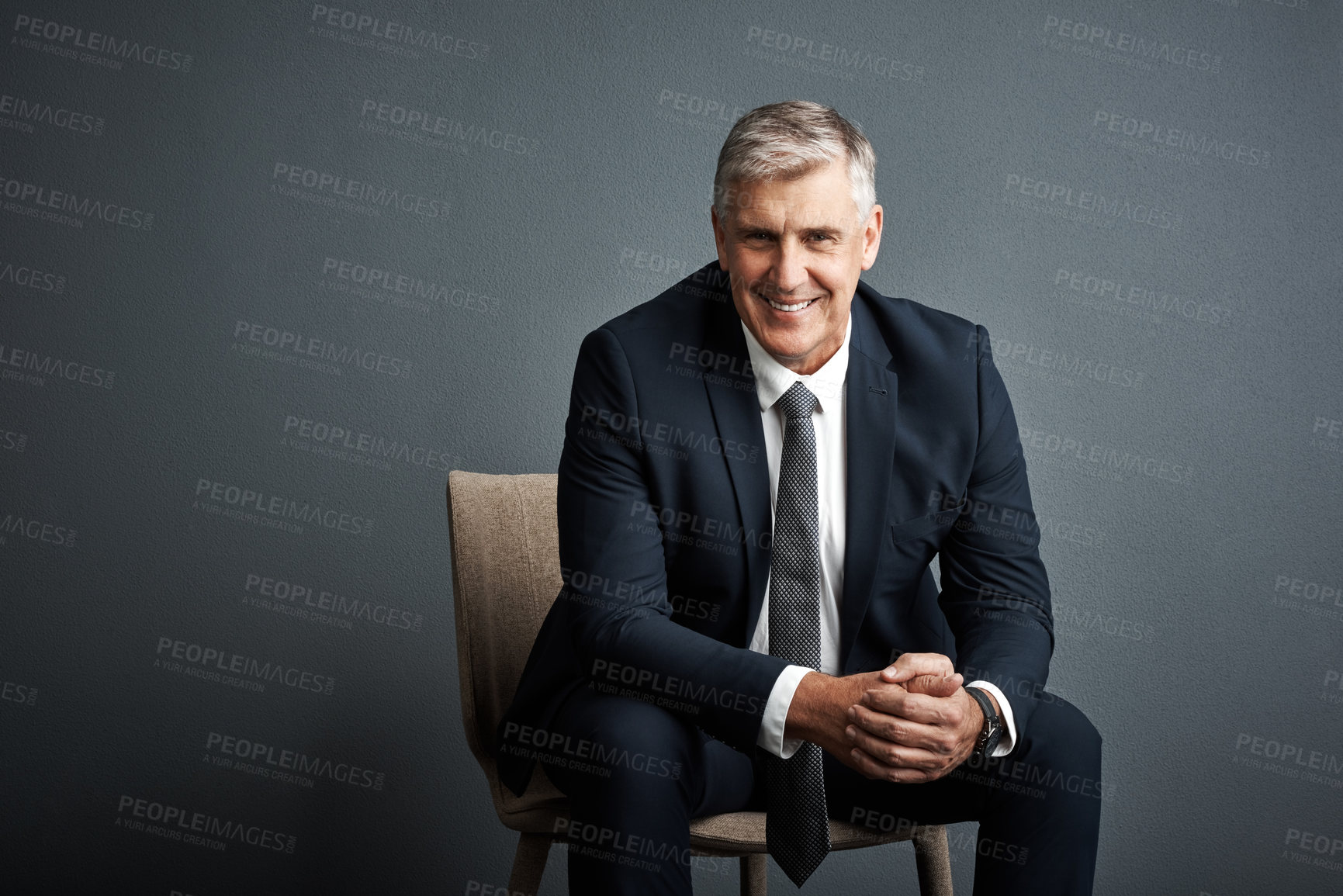 Buy stock photo Studio shot of a mature businessman posing against a grey background