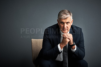 Buy stock photo Studio shot of a mature businessman posing against a grey background