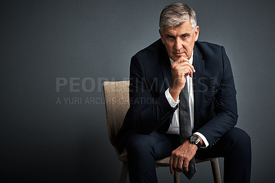 Buy stock photo Studio shot of a mature businessman posing against a grey background