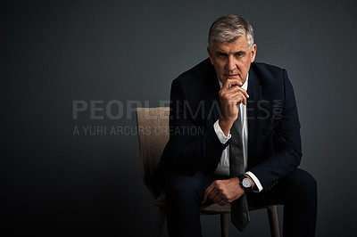 Buy stock photo Studio shot of a mature businessman posing against a grey background