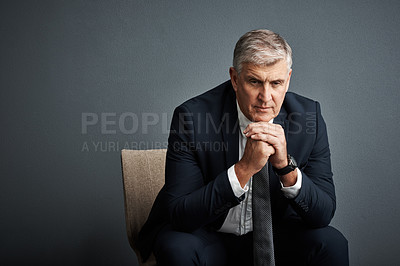 Buy stock photo Studio shot of a mature businessman posing against a grey background