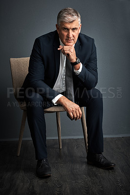 Buy stock photo Studio shot of a mature businessman posing against a grey background