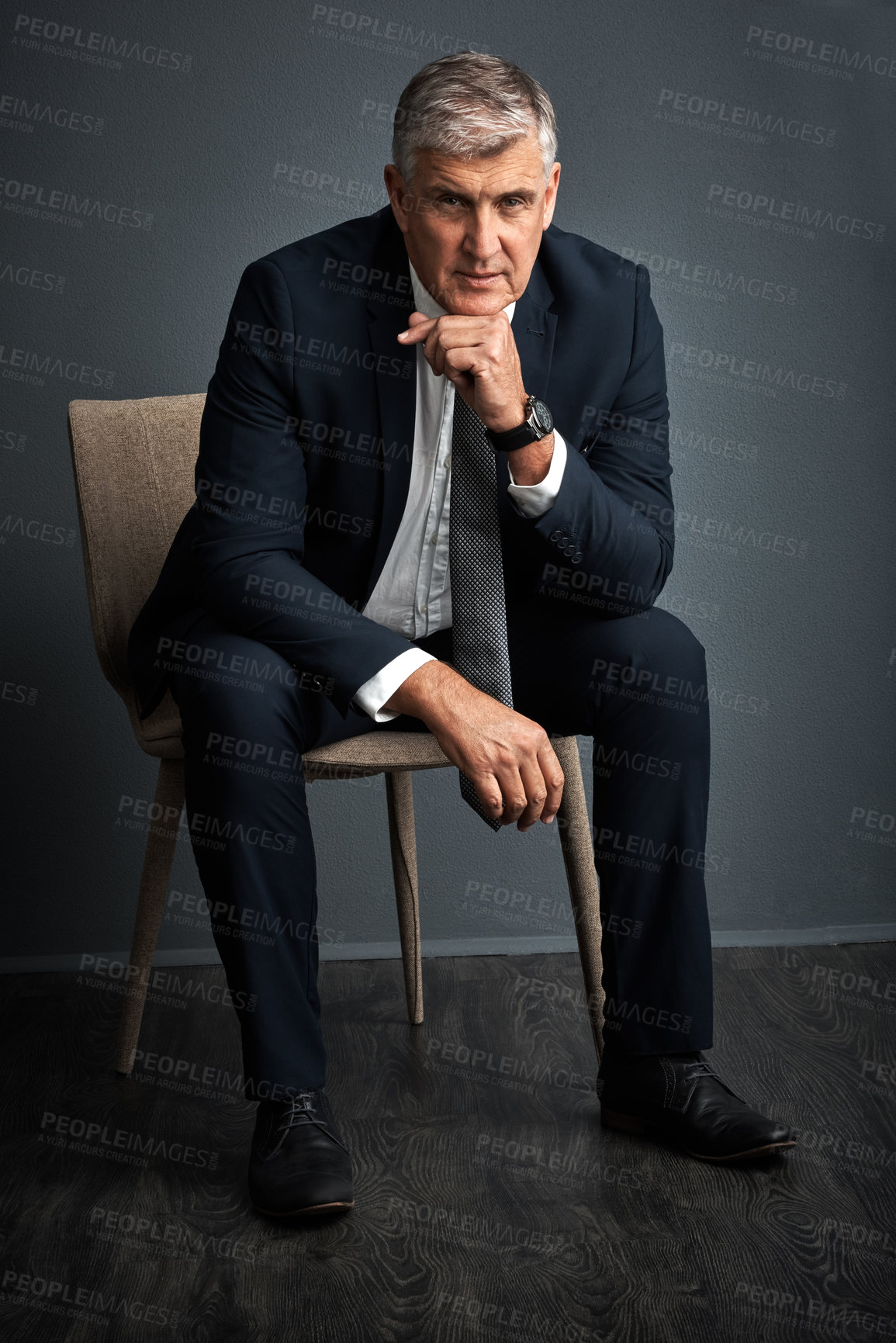 Buy stock photo Studio shot of a mature businessman posing against a grey background