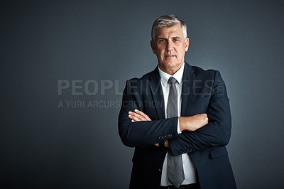 Buy stock photo Studio shot of a mature businessman posing against a grey background