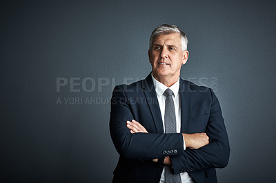 Buy stock photo Studio shot of a mature businessman posing against a grey background