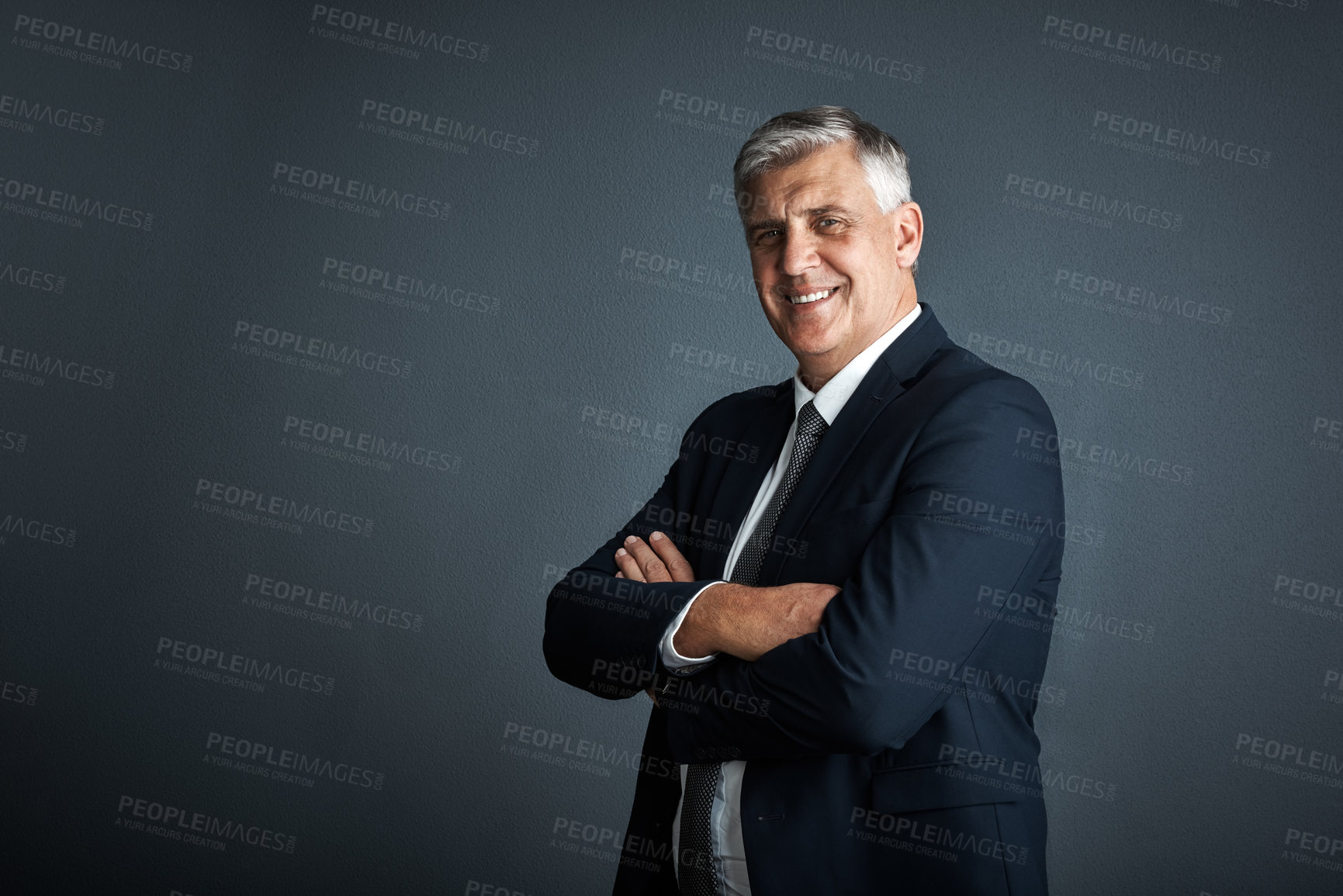 Buy stock photo Studio shot of a mature businessman posing against a grey background