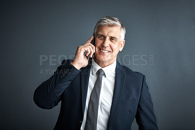 Buy stock photo Studio shot of a mature businessman talking on his cellphone