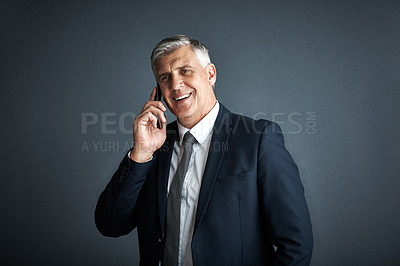 Buy stock photo Studio shot of a mature businessman talking on his cellphone