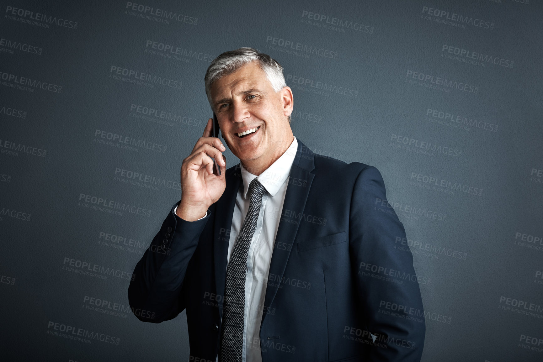 Buy stock photo Studio shot of a mature businessman talking on his cellphone