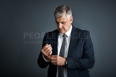 Buy stock photo Studio shot of a mature businessman posing against a grey background