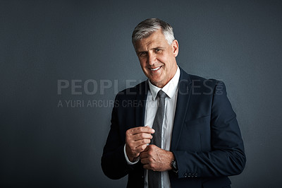 Buy stock photo Studio shot of a mature businessman posing against a grey background