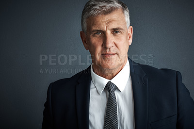 Buy stock photo Studio shot of a mature businessman posing against a grey background