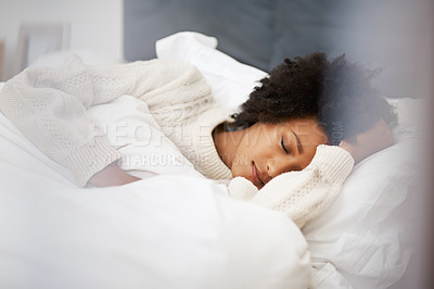Buy stock photo Shot of a young woman sleeping in her bed at home