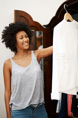 Buy stock photo Happy black woman, clothes and choice at closet in home, morning preparation or getting ready for date. Wardrobe, fashion and girl with decision in bedroom, fabric and think of textile for dressing