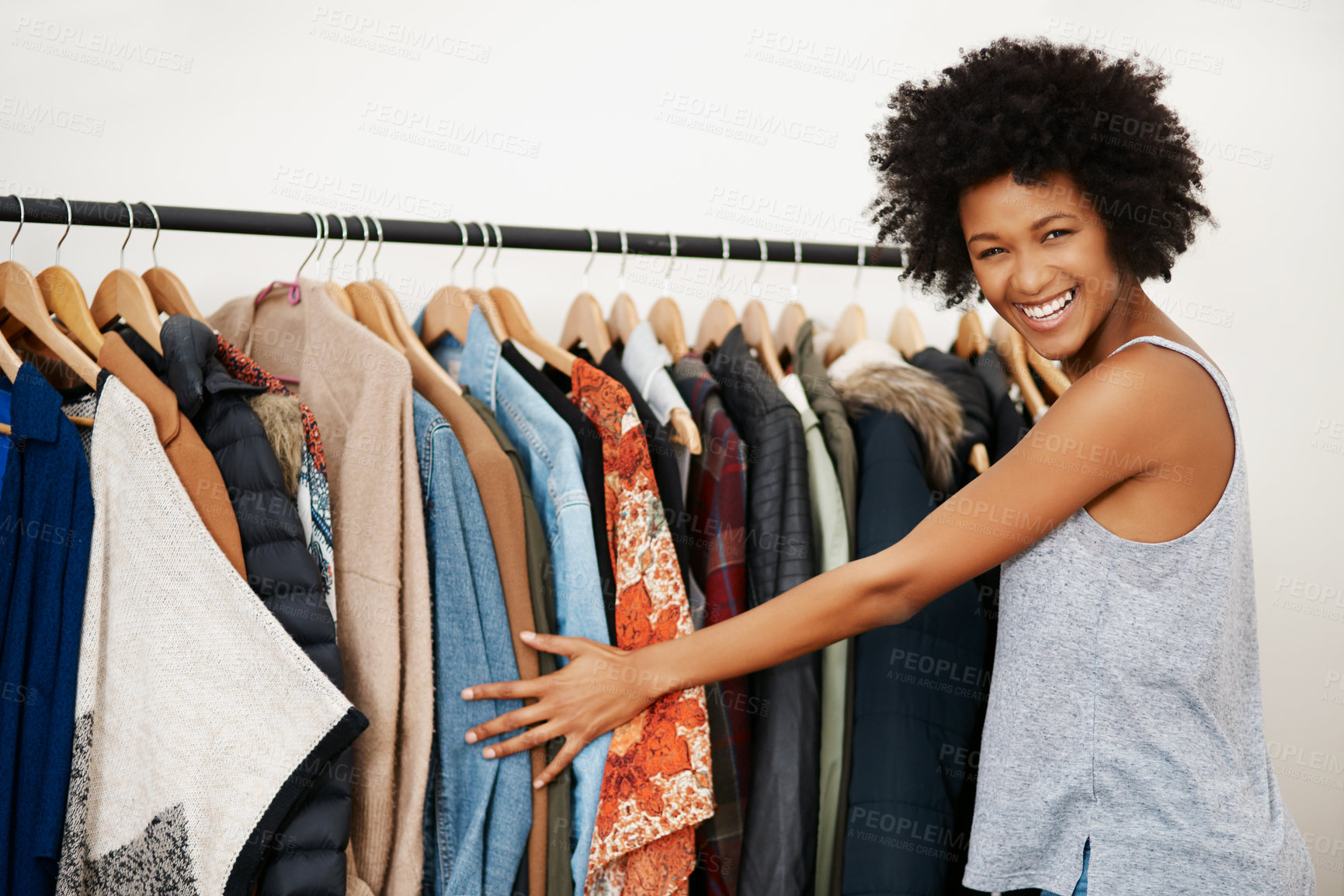 Buy stock photo Woman, portrait and rail with clothes in closet with smile for fashion, choice and excited to start morning. Girl, African person and happy with style, decision and routine by wardrobe in apartment