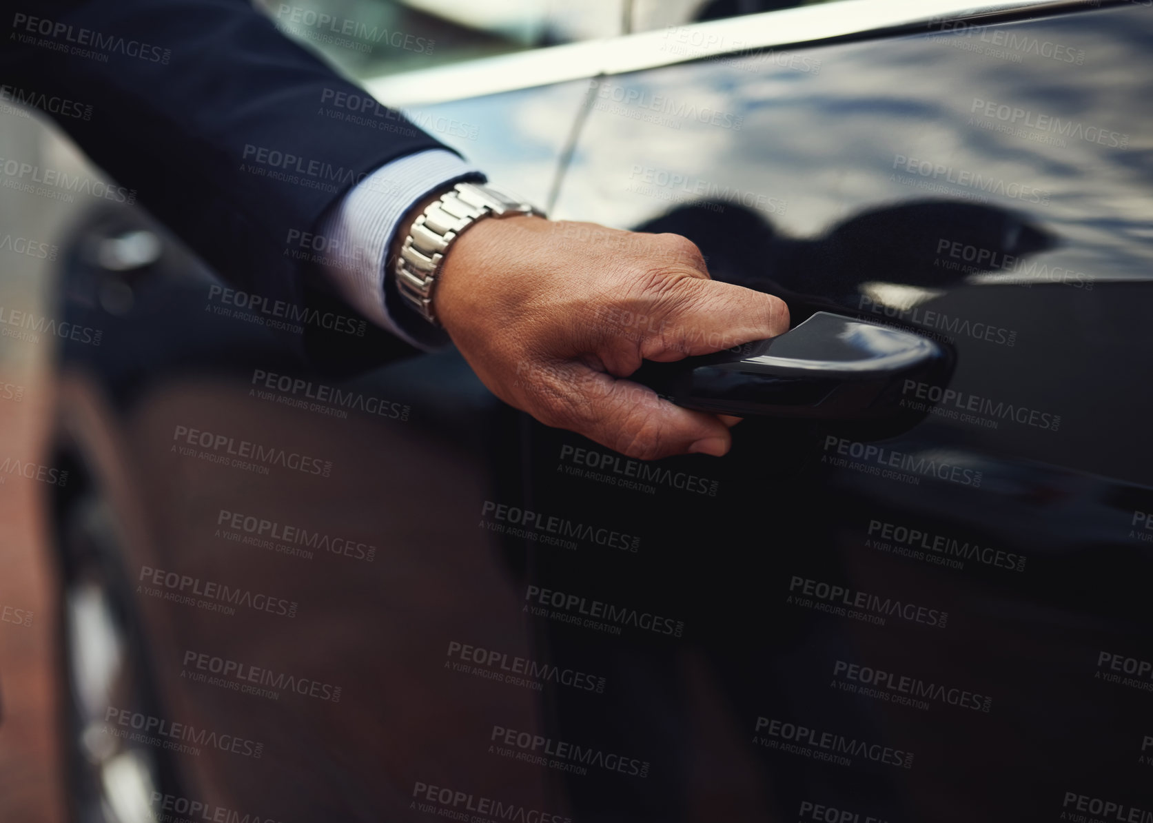 Buy stock photo Cropped shot of a businessman opening a car door