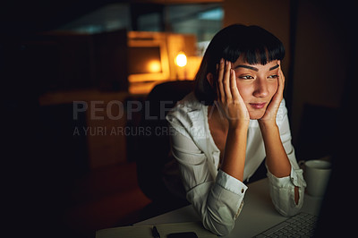 Buy stock photo Shot of a young businesswoman feeling tired during a late night at work