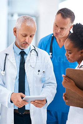Buy stock photo Doctor, tablet and teamwork in a hospital with a mature manager with healthcare workers with tech. Clinic, cardiology research and digital report with conversation and collaboration with discussion