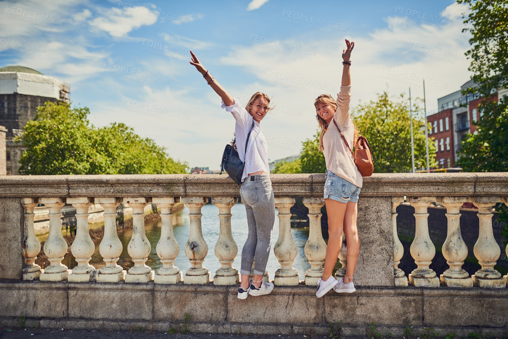 Buy stock photo Rearview portrait of two attractive young girlfriends exploring a foreign city