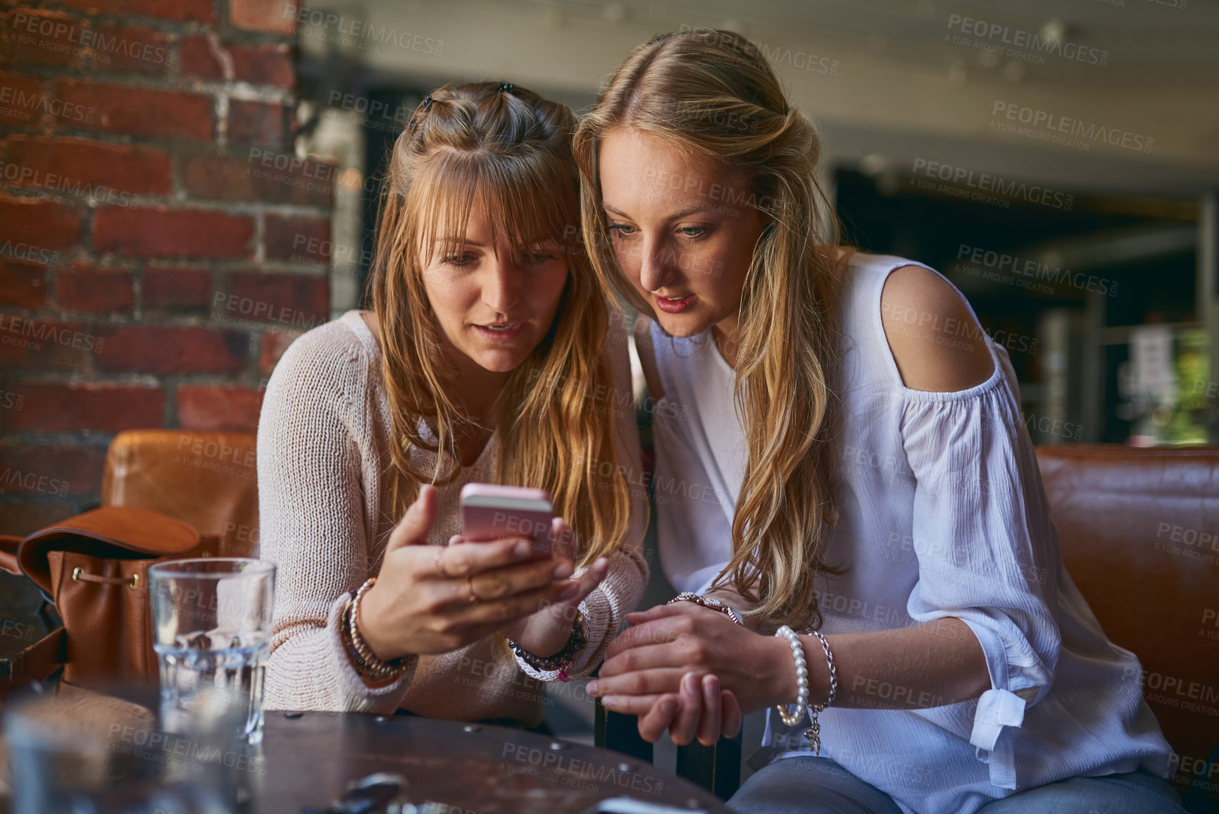 Buy stock photo Coffee shop, friends and women with phone online in restaurant for talking, social media and relax. Cafeteria, happy and people on smartphone with beverage, lunch and drink in cafe on weekend